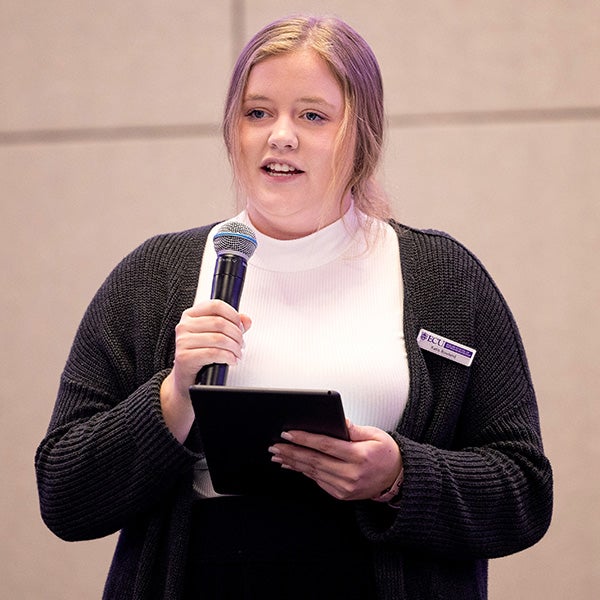 Katie Rowland of Fosterline Support addresses the crowd during the second round of the sixth annual Pirate Entrepreneurship Challenge. Six teams have progressed to the final round scheduled for April 6 at Harvey Hall. 