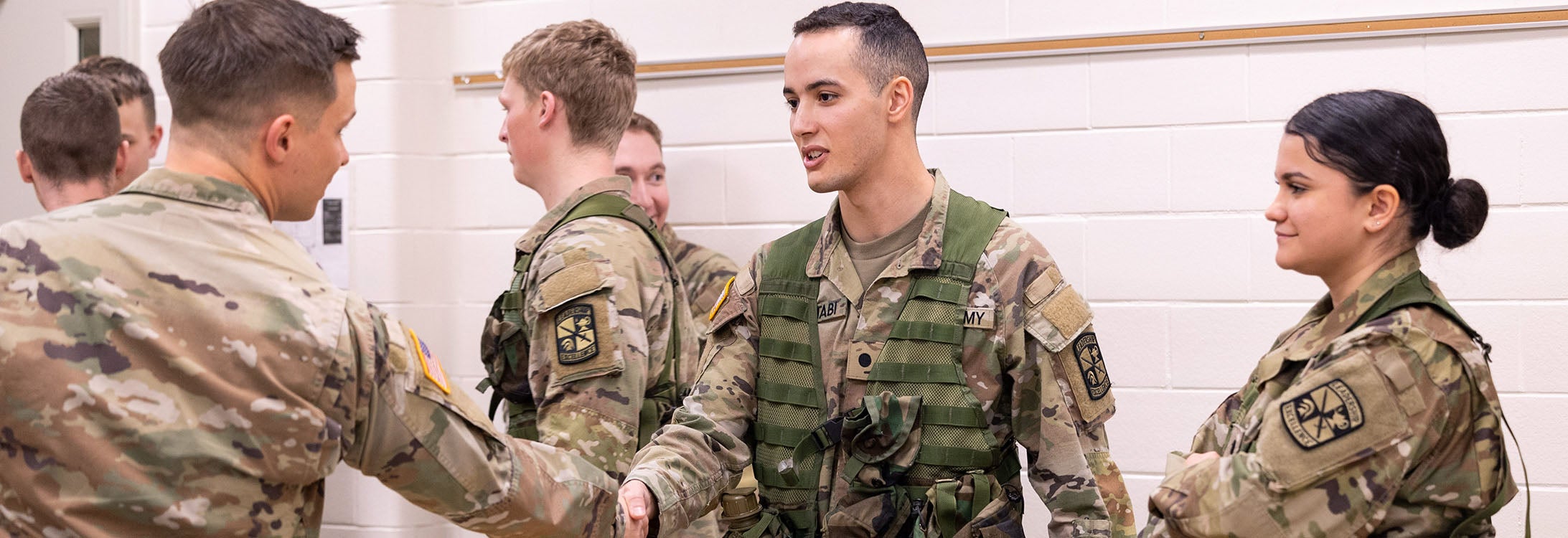 East Carolina University Army ROTC member Sifeddine Chettabi shakes hands with 112th Special Operations Signal Battalion (Airborne) Capt. Ausdin Pender during a visit to campus. Army leaders spoke to students about career aspirations, while ECU representatives shared their leadership and lab experiences.