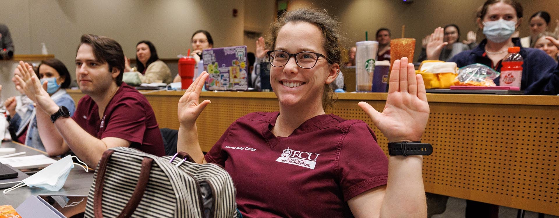 ECU dental students practice hand stretching exercises taught by occupational therapy students.