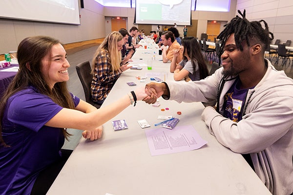 Grace Marks and Latrell Ruffin shake hands during Campus Recreation and Wellness’ Speed Friending event. 