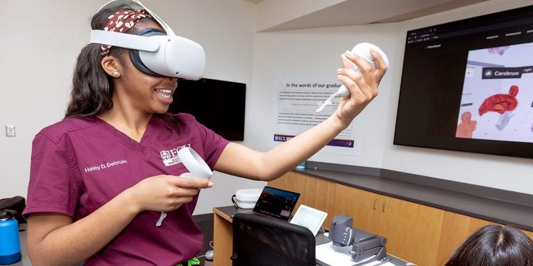 East Carolina University School of Dental Medicine first-year dental student Haley Debnam tries out virtual reality equipment during class as she and her classmates learn the anatomy of the brain, head and neck.