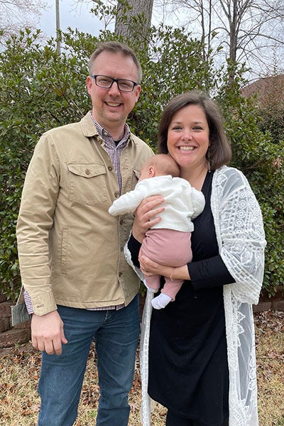 Julianne and Matthew Szymanksi hold Baby H. Baby H was adopted last semester while Julianne was in nursing school. 