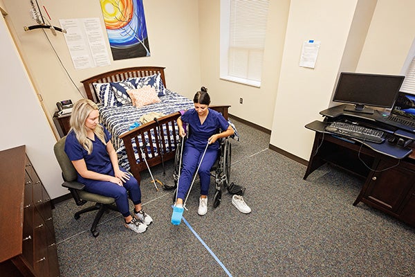 Occupational therapy student practice activates of daily life skills.