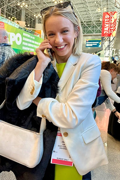 ECU senior Emma Smith smiles as she talks with a Burlington representative to accept a job offer while in New York at the National Retail Federation Student Program. 