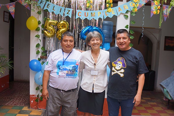 Larson poses with Guatemalan partners at a birthday party during a cultural outreach trip with students to Guatemala.