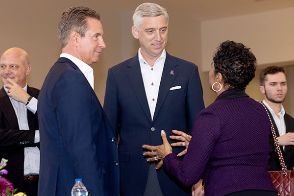 East Carolina University Chancellor Philip Rogers, center, speaks with Pirate Entrepreneurship Challenge judges John May, left, and Sonja Nichols.