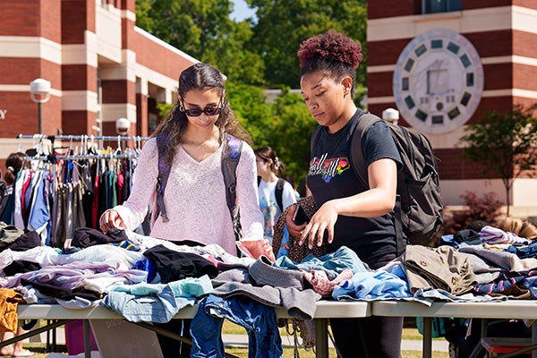 Students shop at the third Pirate Swap pop-up thrift shop during Friday’s Earth Day festival on the Main Campus Student Center lawn.