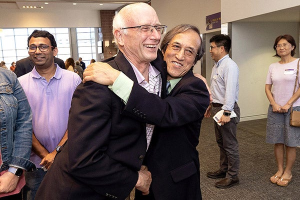 Yu "Frank" Yang, right, is congratulated by former East Carolina University Graduate School Dean Paul Gemperline after accepting the Lifetime Achievement Award for Excellence in Research and Creative Activity.