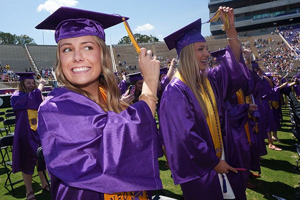 New ECU graduates turn their tassels during the commencement ceremony.