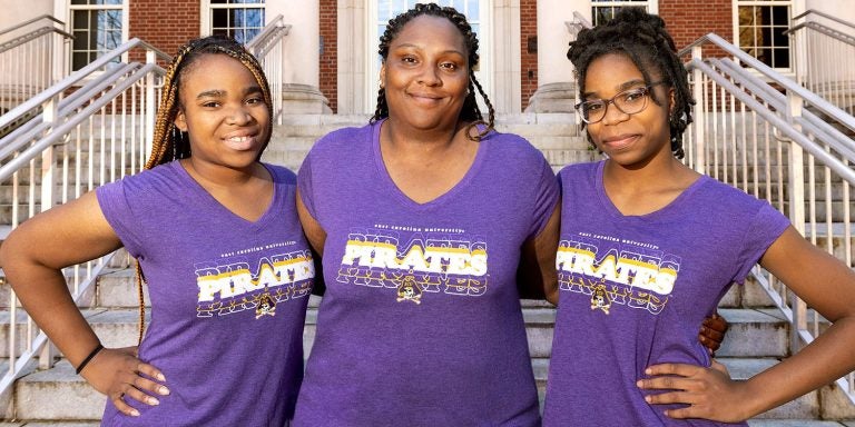 Tanisha Grimes, middle, a housekeeping supervisor at ECU, stands with two of her six children on ECU’s campus. Ashawndrea, left, is a rising senior in the clinical laboratory science program and Ashari attends Innovation Early College High School at ECU.