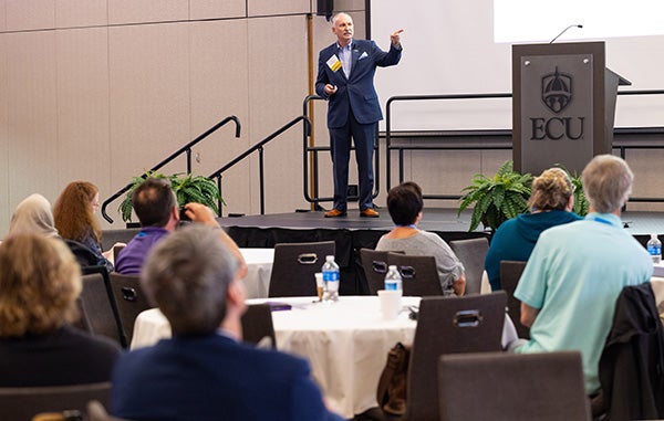 Mark Phillips, vice president of statewide operations and executive director of the eastern regional office for the N.C. Biotechnology Center, speaks during East Carolina University's annual Spring Pharma Conference at the Main Campus Student Center. 