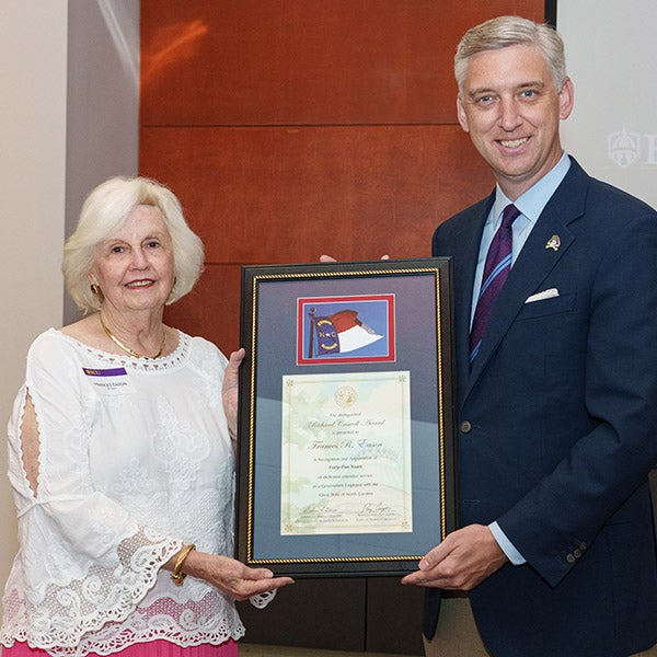 Frances Eason, left, receives the Richard Caswell Award from Chancellor Philip Rogers. 
