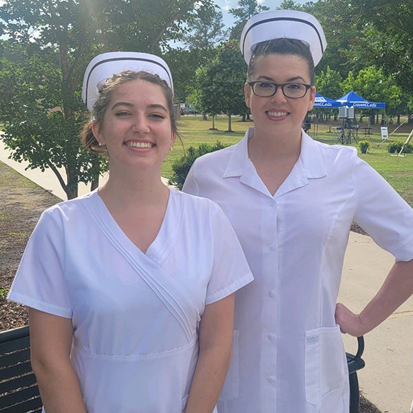 East Carolina University nursing students Keelin, left, and Jessica Van Wagenen pose at Craven Community College for a nursing event.