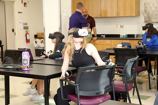 Students in Mark Newton’s science education classes used virtual reality headsets to explore how climate change is affecting barrier islands like the Outer Banks. 