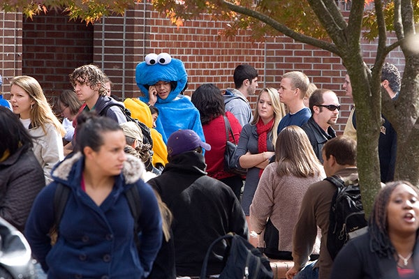 Cookie Monster takes a call while waiting outside Bate Building.