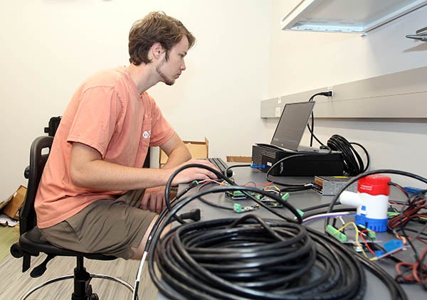 Engineering student Daniel Franklin works on the monitoring
