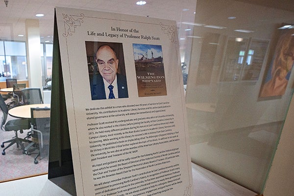 A memorial is displayed for East Carolina University honorary professor emeritus Ralph Scott on the first floor of the main campus library.