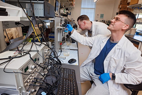 Doctoral candidates Everett Minchew, right, and Nick Williamson work in the Spangenburg Lab at East Carolina University.