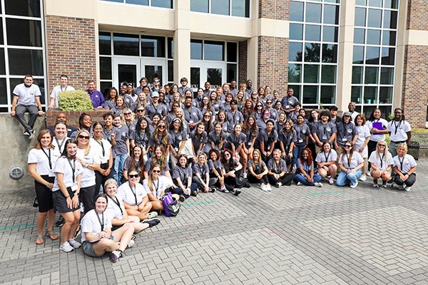Manning, bottom left, stands with the participants of the Future Teachers of NC symposium at ECU.