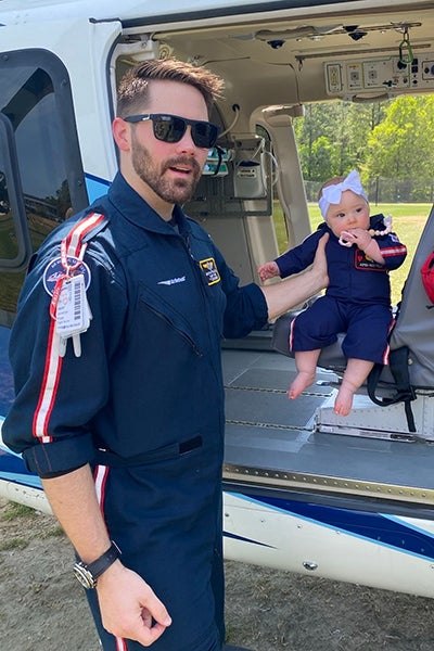 Polak poses with his daughter in an air ambulance.