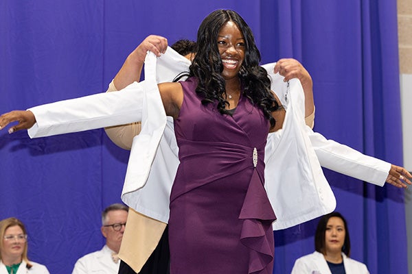 Onolunosen Abhulimen smiles as she receives her coat during a White Coat Ceremony on Friday. 