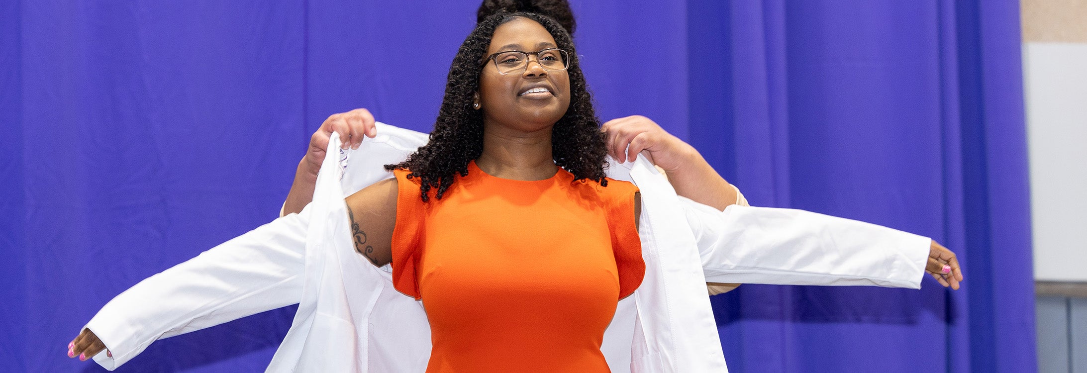 Monique Howell, a first year medical student in East Carolina University's Brody School of Medicine, receives her white coat during the university's annual White Coat Ceremony on Friday. (ECU photos by Rhett Butler)