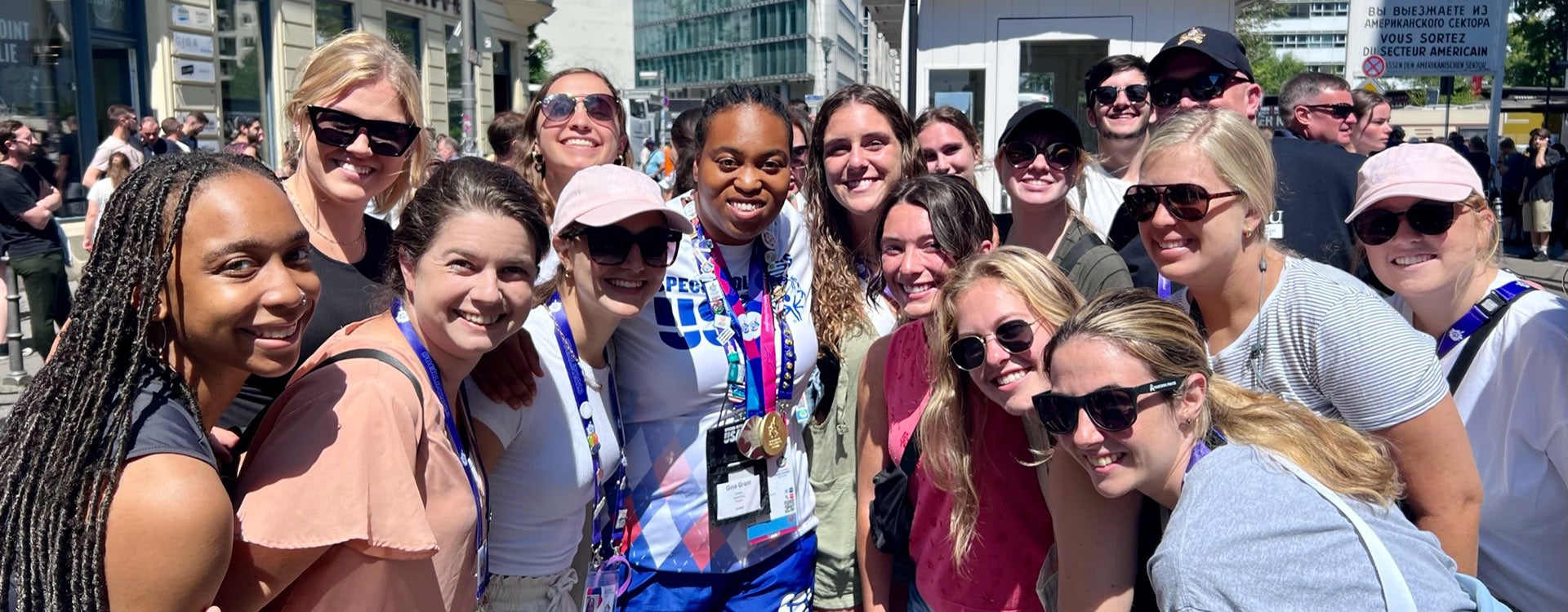 Volunteers from ECU smile with an American athlete at the Special Olympics World Games in Berlin.
