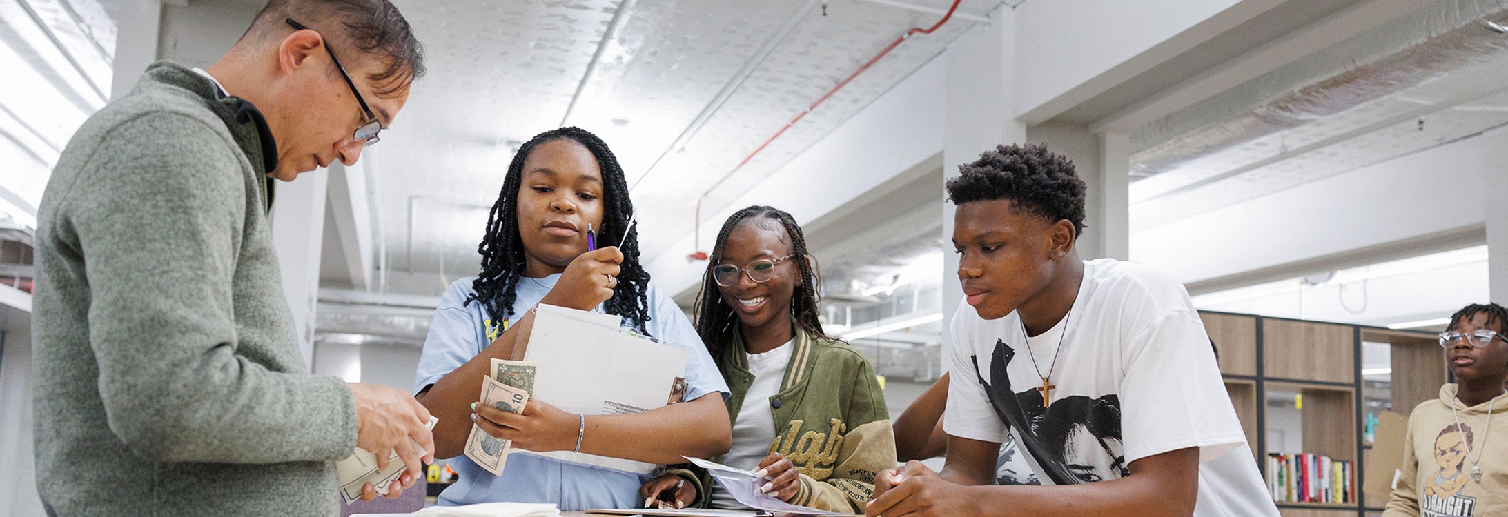 Summer Innovation Academy students participated in an entrepreneurship lifecycle exercise that featured the assistance of College of Business faculty and staff. Pictured, left to right, Micah Sam (COB), and students Katelynn Horton, Morgan Taylor and Amari Leach. (Photo by Steven Mantilla)