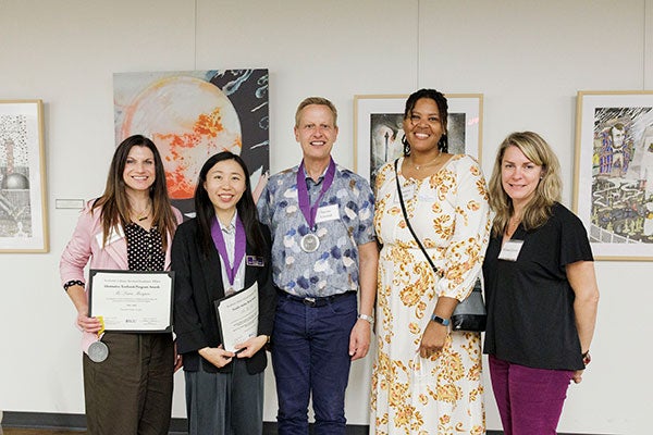 A group of five Alternative Textbook Program award winner smiling.