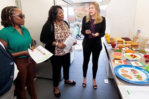 Cari Jones, graduate student in nutrition science, gives a tour of the new Farm 2 Clinic mobile teaching kitchen and pantry while discussing healthy eating habits. (ECU Photo by Rhett Butler) 
