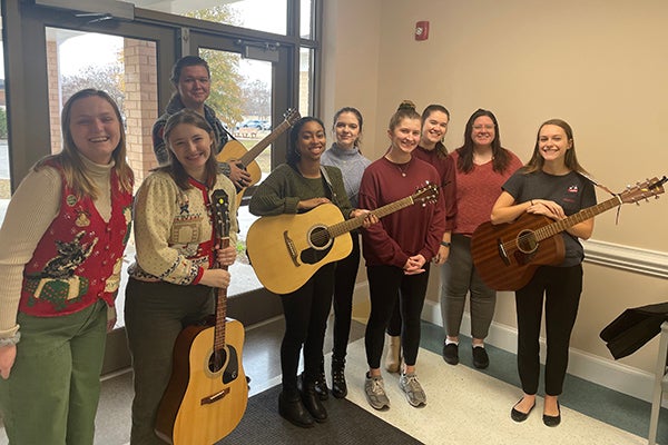 Ella Chapman, far left, joins members of the East Carolina University Music Therapy Organization for a service project last year to sing carols for Pitt County Council on Aging participants.