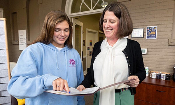 Two women review paper work. Dr. Katie ford stands on the right. 