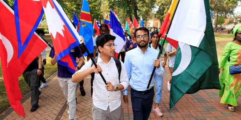 Roshan Saud of Nepal and Muhammad Kamran of Pakistan carry their countries’ flags during a Parade of Flags ceremony. (ECU photos by Rhett Butler)