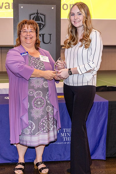 Dr. Kathy Cox, interim dean of the Graduate School, presents Madison Rose with the Grand Champion award at the 2023 Three Minute Thesis competition. (Contributed photo)