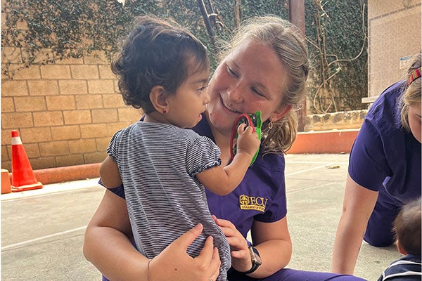 College of Nursing students interact with children at an orphanage during their three-week visit to learn Spanish and share their medical knowledge. 