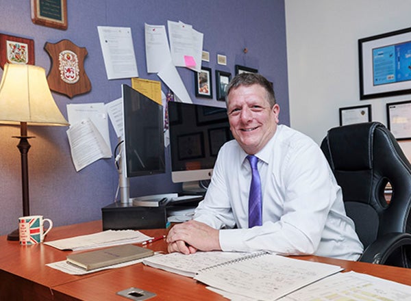 Dr. John Cavanagh, pictured in his office in ECU’s Brody School of Medicine, says ECU’s mission is woven into the work he does as a professor and chair of the Department of Biochemistry and Molecular Biology. 