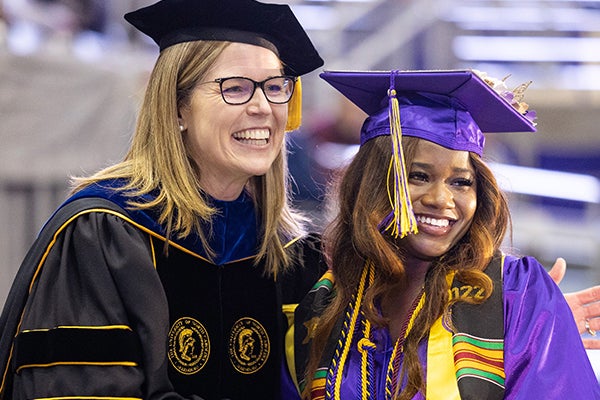 Dr. Michele Wallen smiles with a graduating student during a past College of Health and Human Performance graduation recognition ceremony. (ECU News photos)