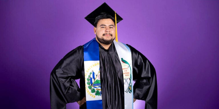 Marcos Ardon Lobos stands in graduation cap and gown.