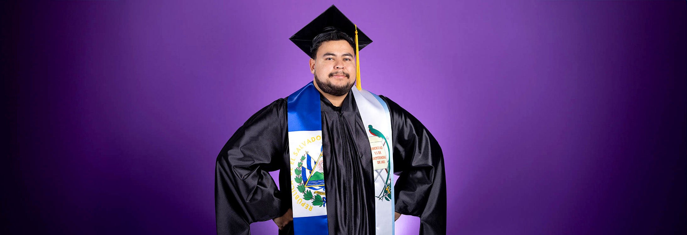 Marcos Ardon Lobos stands in graduation cap and gown.