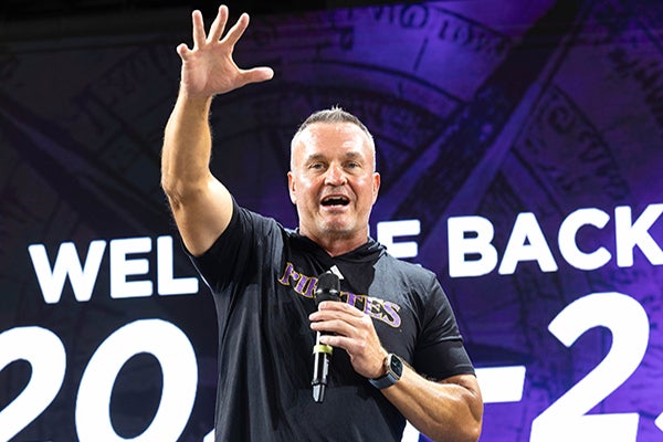 Head football coach Mike Houston leads the “Purple! Gold!” cheer at New Student Welcome. (ECU photo by Rhett Butler)