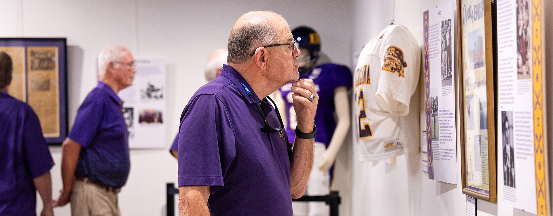 Ted Salmon, one of the 1970 East Carolina football players, looks at a panel in the “No Quarter: The History of East Carolina Football and Dowdy-Ficklen Stadium” exhibit.
