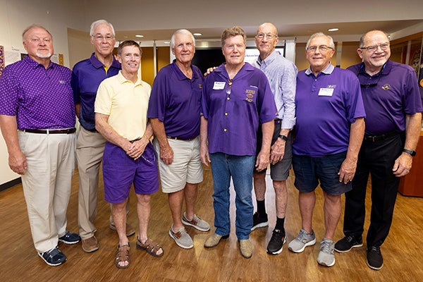 Members of the 1970 East Carolina football team take a photo together at the “No Quarter: The History of East Carolina Football and Dowdy-Ficklen Stadium” exhibit.