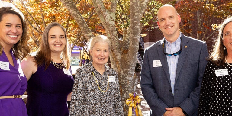 Adrienne Steiner-Brett and Ginny Driscoll, assistant professors of music therapy, along with Pitt County Group Homes Foundation President Jacob Parrish and Executive Director Mary Grace Bright receive a plaque for ECU’s new on-campus music therapy clinic. (Photos by Rhett Butler)
