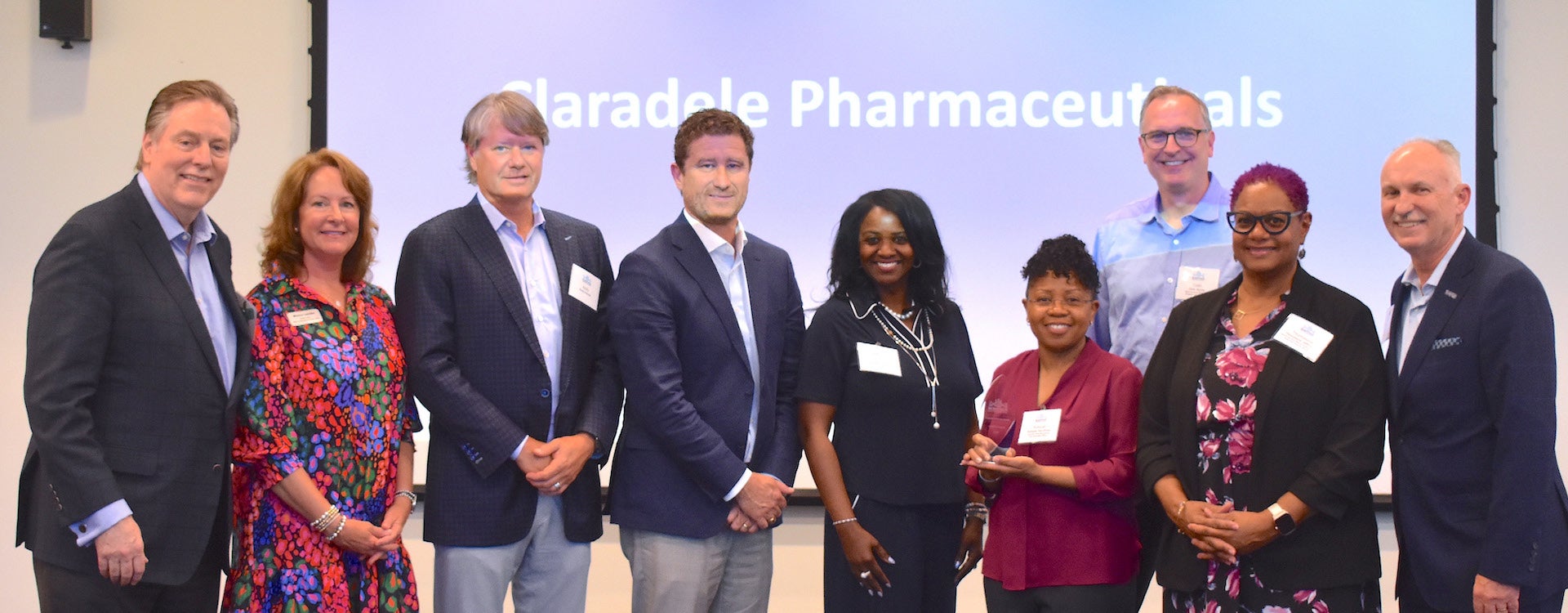 Dr. Rukiyah Van Dross-Anderson with her business partner, Dr. Colin Burns, challenge judges and NC Biotechnology Center representatives. (Photo by Kim Tilghman)