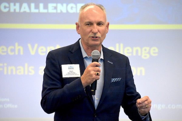 : Mark Phillips, vice president of statewide operations and executive director of the eastern regional office for the NC Biotechnology Center, introduces each challenger ahead of their prepared two-minute pitch. (Photo by Kim Tilghman)