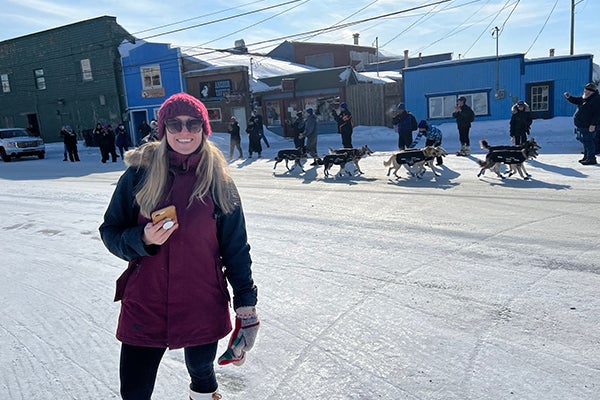 ECU speech-language pathology student Erin Baginski watches the the Iditarod Trail sled dog race in Alaska. (Contributed photo)