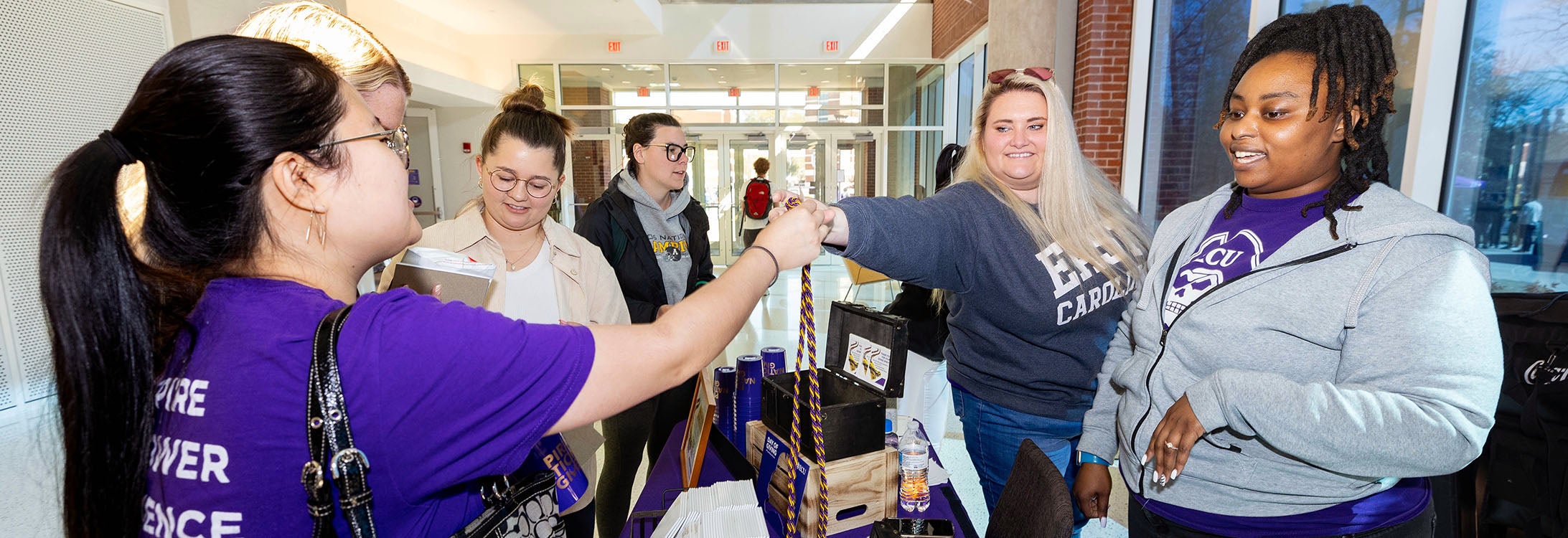 Summer Edwards, center, director of university scholarships, and Zenaia Ward, administrative support specialist, participate in Pirate Nation Gives at the Main Campus Student Center at ECU. (Photo by Rhett Butler)