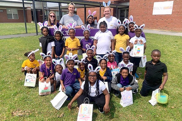 ECU's Tau chapter of Phi Sigma Pi hosted an Easter egg hunt for students at the ECU Community School, just one of several service projects the chapter organizes each year.
