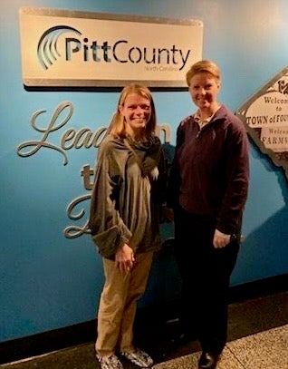 Melanie Sartore-Baldwin, left, stands with College of Health and Human Performance interim dean Stacey Altman in December when Sartore-Baldwin was honored by the Pitt County Board of Commissioners for her Governor’s Volunteer Service Award.