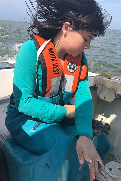 Van Etten works with a sound receiver while participating in flounder field work on board ECU’s research vessel Sound Byte. 